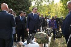 President Vučić and King Mswati III inspect the display of a part of arms and military equipment